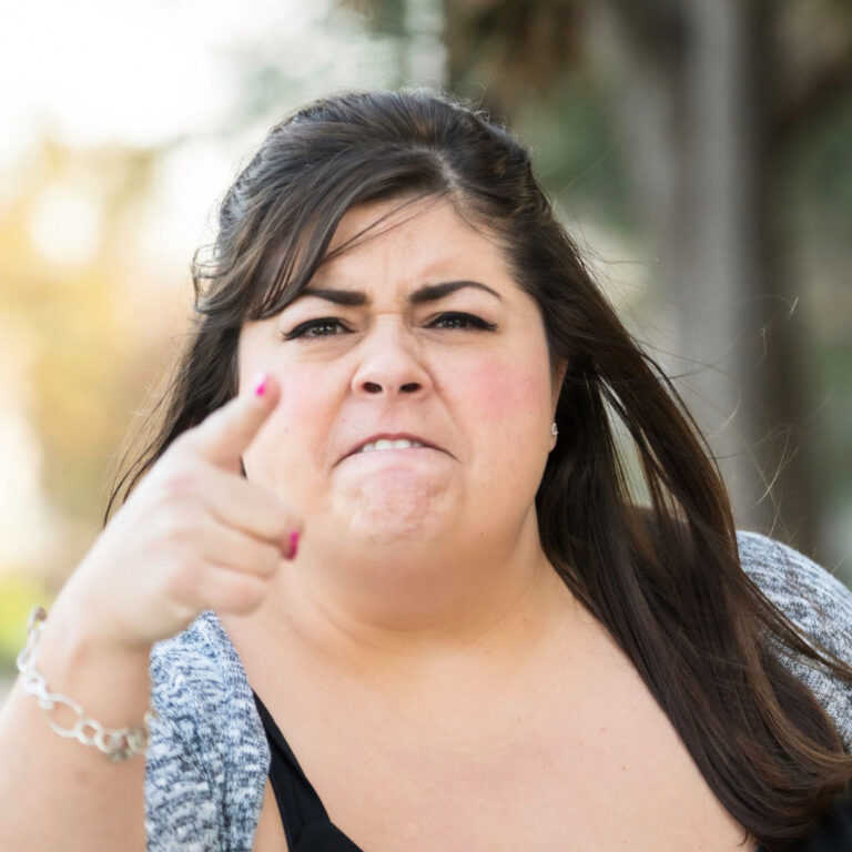 Angry woman pointing a finger at the camera fit shaming