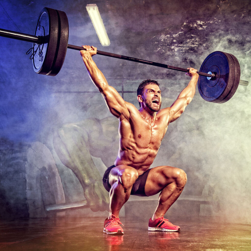 muscular man lifting a heavy barbell overhead