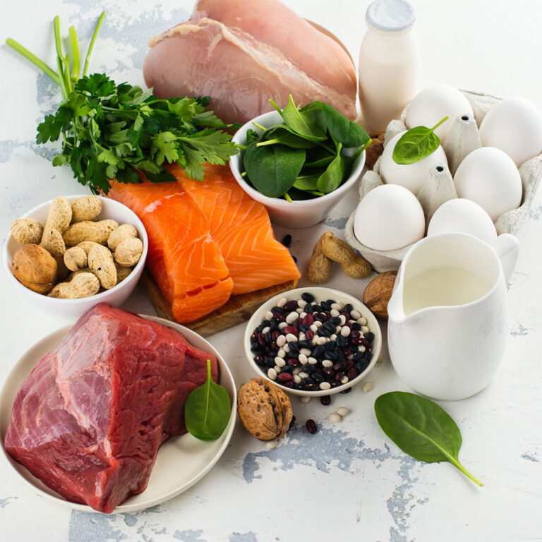 Image of a group of high protein foods including salmon, eggs, and beef that can be part of a healthy diet