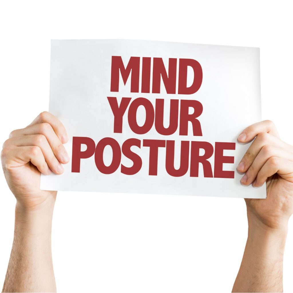 Person holding up a sign that says "Mind Your Posture"