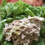 Scoop of tuna salad on lettuce with tomatoes