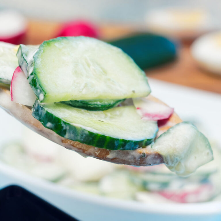 Creamy cucumber radish salad on a spoon