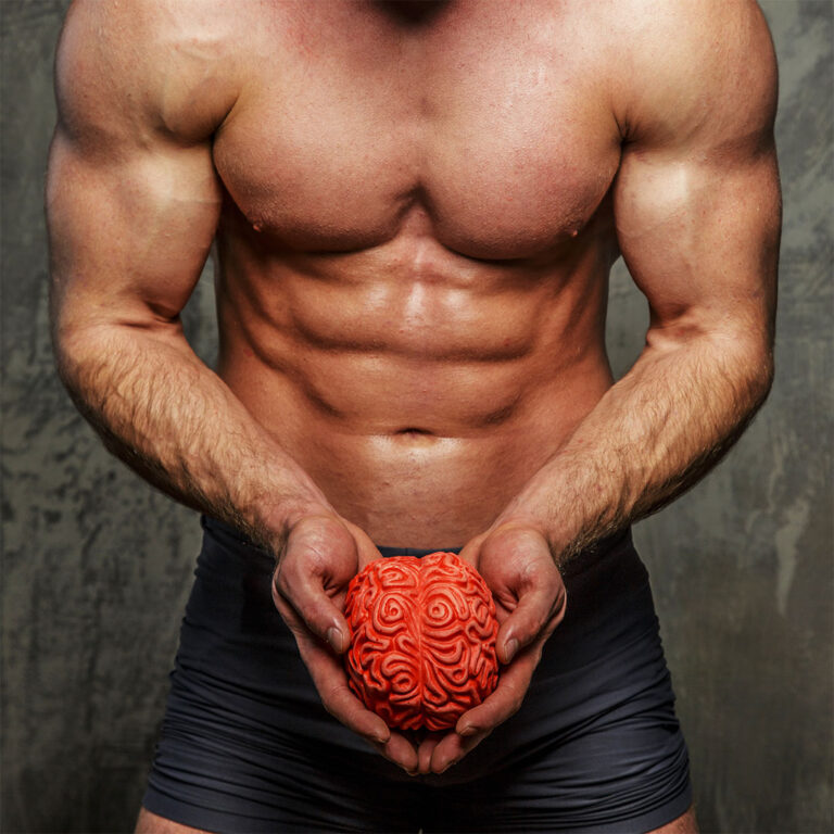 Muscular man on gray background holding a red model of a brain between his hands