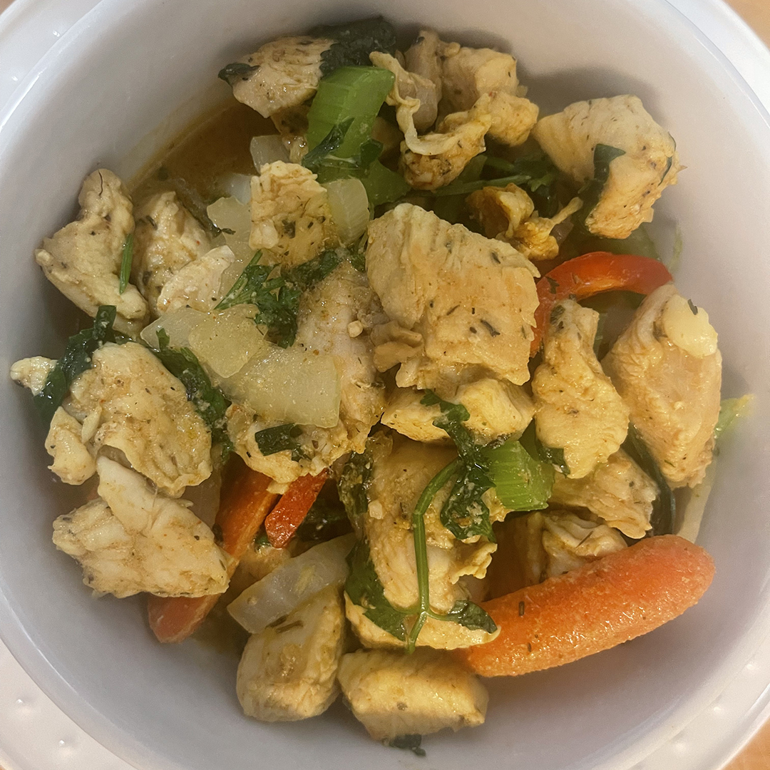 Bowl of Chicken Curry featuring chicken thighs, carrots, onions, celery in a flavorful broth of coconut milk and green curry paste